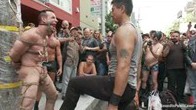 Muscle slave is stripped naked, used and humiliated while hordes of people take photos